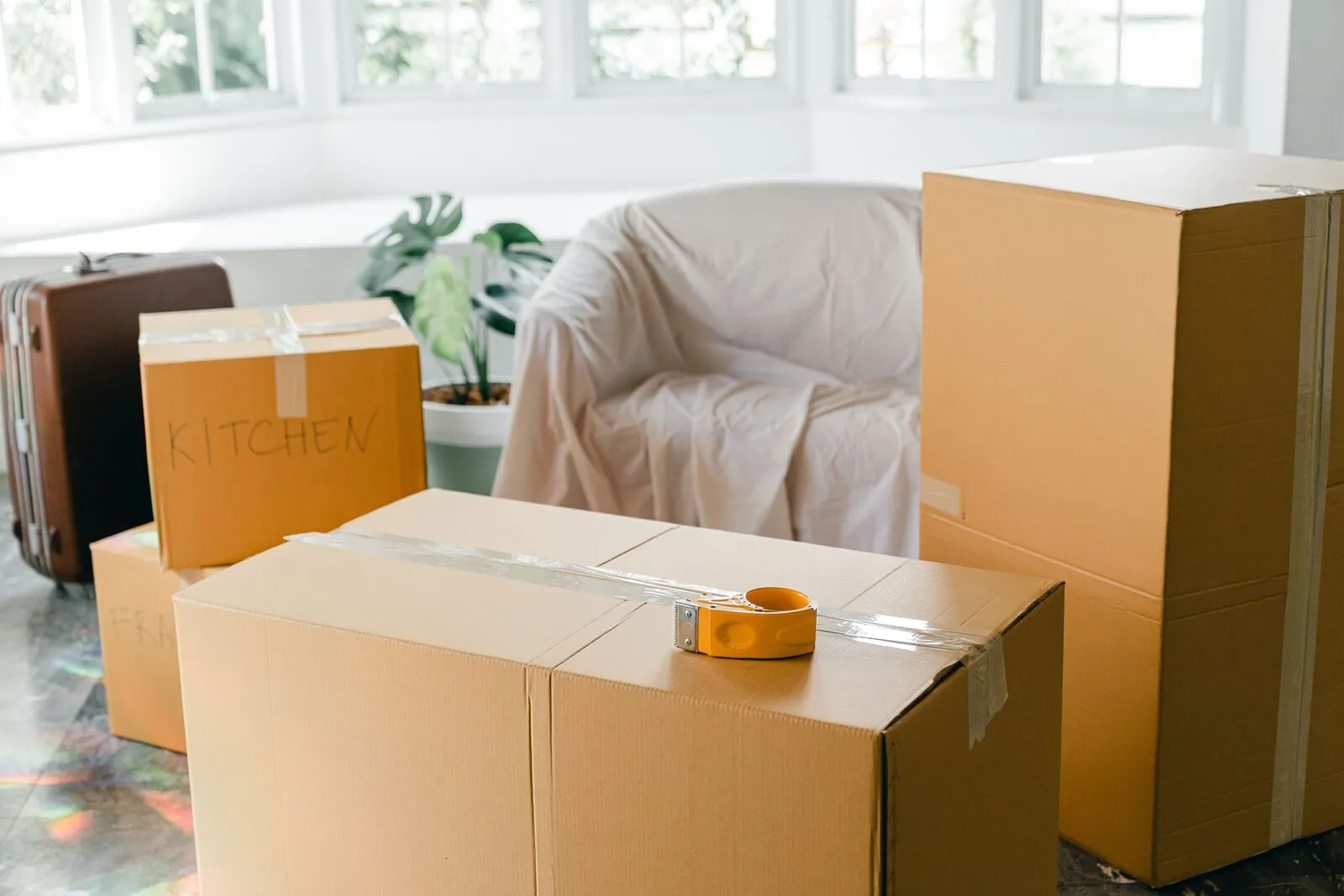 Bright, empty apartment with moving boxes, ready for a fresh start